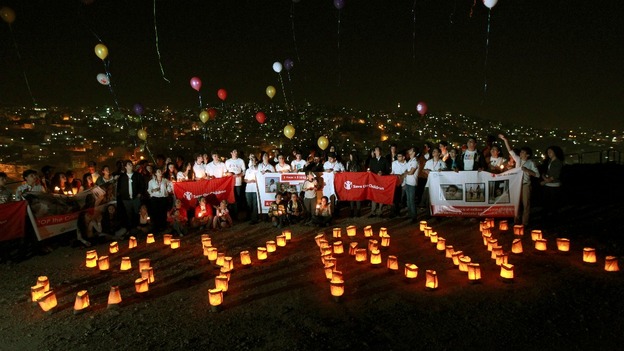 Syrian refugees in Ammam release balloons and form the word "Syria" with candles to mark the second anniversary