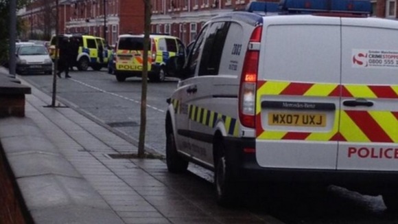 Police have surrounded the house on North Lonsdale Street in Gorse Hill.