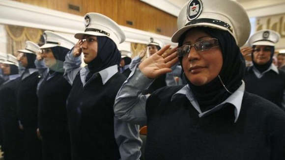 Iraqi policewomen salute as the Iraqi national anthem is played during a ceremony celebrate International Women's Day in Baghdad in 2009