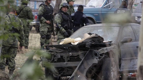 Soldiers stand guard near the site of the explosion.