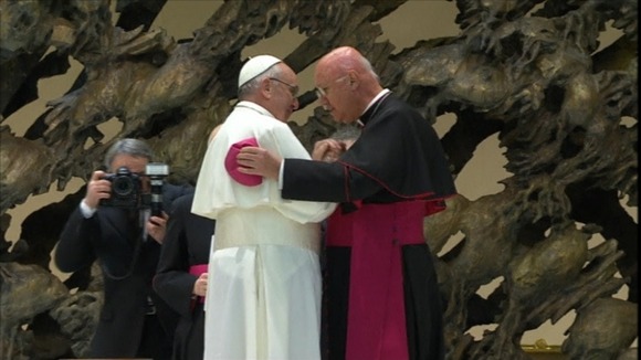 Pope Francis greets a cardinal at the press conference