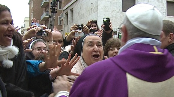 Newly elected Pope Francis greets crowds gathered in the Vatican