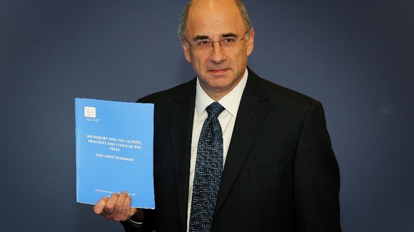Lord Justice Leveson with the Report from the Inquiry into the Culture, Practices and Ethics of the Press.