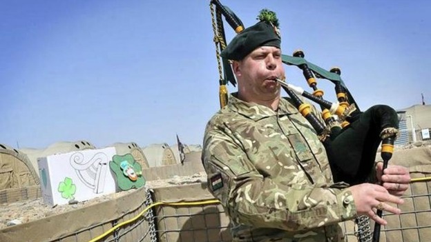 Pipe Major Scott pipes during the ceremony held in Afghanistan’s 30C desert sun.
