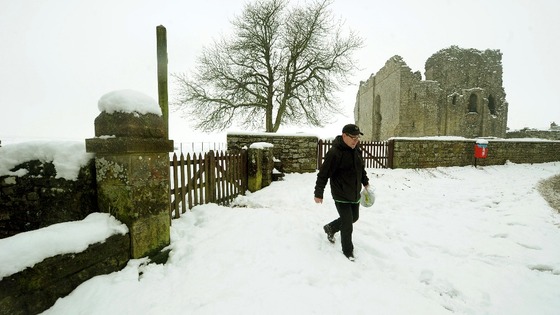 A man takes a walk through the grounds of Bowes Castle in County Durham