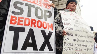 Protesters hold up signs against the bedroom tax