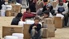 Newly arrived Syrian refugees wait to receive aid and rations at Al-Zaatri refugee camp in the Jordanian city of Mafraq in January