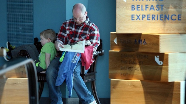 A man reads information about the Titanic, at the new Titanic Visitor centre in Belfast