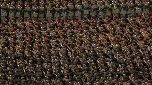 A crowd of military members clap hands at a stadium during a mass meeting of North Korea's ruling party in Pyongyang, North Korea.