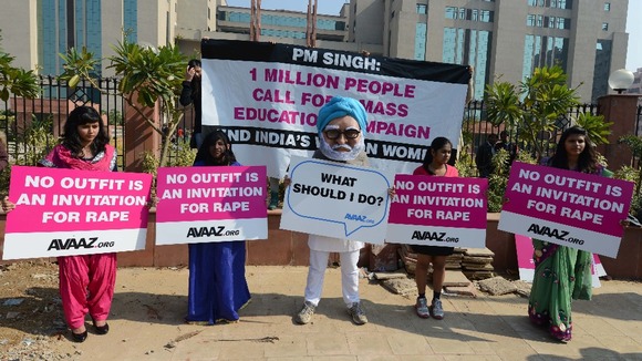 Demonstrators hold placards during an anti-rape protest outside a court in New Delhi.