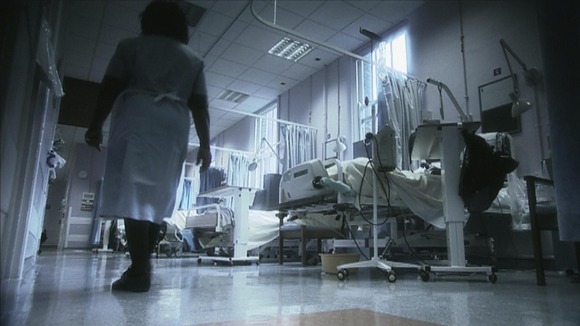 Nurse walking along in hospital ward