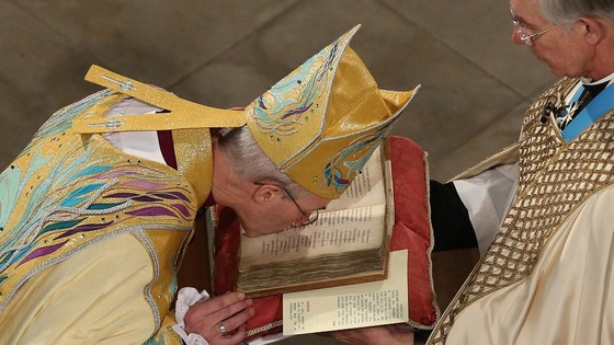 Rt Rev Justin Welby kisses the Canterbury Gospels during his enthronement service