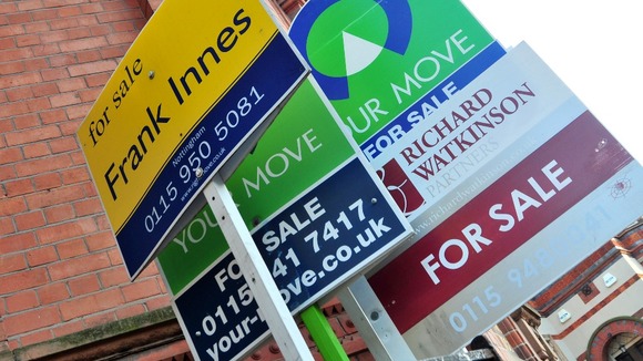 General view of for sale signs outside a block of flats.