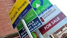 General view of for sale signs outside a block of flats.