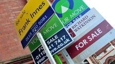General view of for sale signs outside a block of flats.