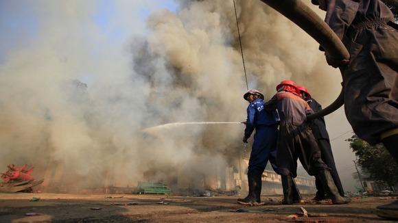 Firefighters attempt to extinguish a fire during riots in Meikhtila