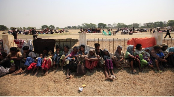 Muslims rest as they take refuge at a stadium amid riots