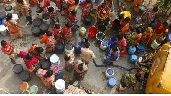 People collect drinking water from a water tanker in Kolkata, India