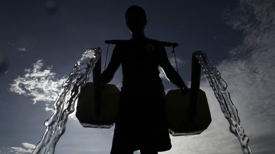 A Filipino farmer pours water in Taguig City. Agriculture is the largest single use of water.