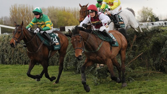 Neptune Collonges ridden by Daryl Jacob (back right in yellow) clears the last fence before going on to win the John Smith's Grand National