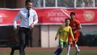 David Beckham plays football on a sports field during his visit in Qingdao