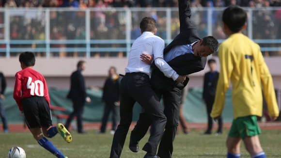 David Beckham holds a former footballer of the Chinese national team
