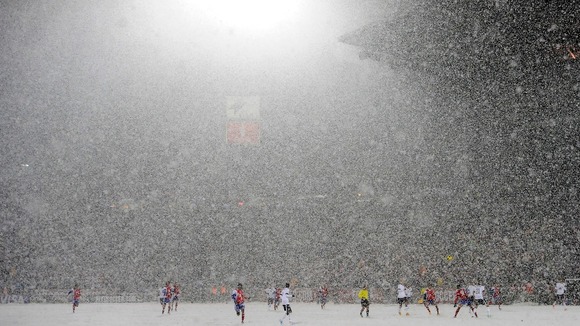 Snow falls during the 2014 World Cup qualifying football match