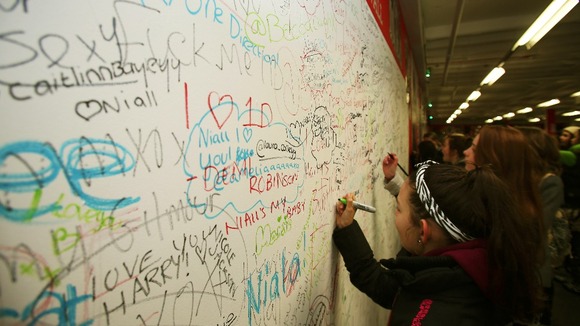 Visitors are invited to write messages to their idols on this wall