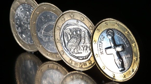 A Cypriot euro coin next to coins from fellow bailout countries Portugal, Ireland and Greece.