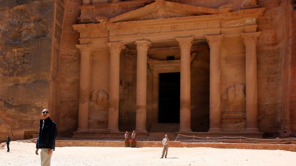 President Barack Obama is dwarfed as he visits Jordan's ancient city of Petra.