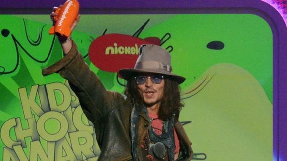 Kids' Choice regular Johnny Depp brandishes his award for Male Butt Kicker of the Year for his vampire film 'Dark Shadows'.