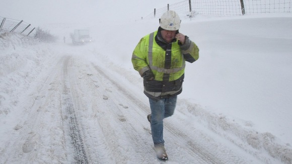 A Northern Ireland Electricity engineer as heavy snow falls in County Antrim.