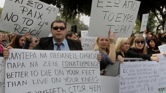 Protesters take part in an anti-bailout rally by employees of Cyprus Popular Bank in Nicosia on March 22.