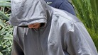 Oscar Pistorius escorted by police to his local police station in Pretoria on February 14.