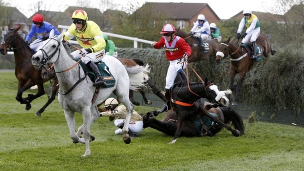 According to Pete ridden by Harry Haynes (in red) falls after jumping Becher's Brook in the Grand National