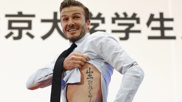 David Beckham shows off the tattoo at a news conference