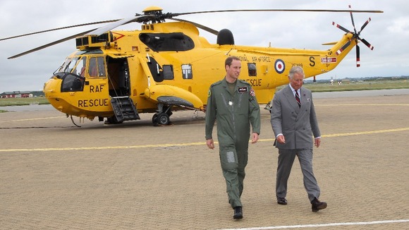 The Duke of Cambridge shows his father one of the RAF's distinctive yellow Sea King helicopters at RAF Valley on Anglesey