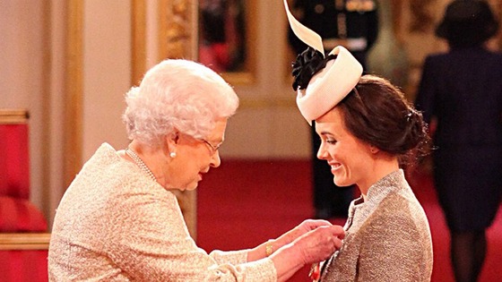 Cyclist Victoria Pendleton receiving her CBE from the Queen today.