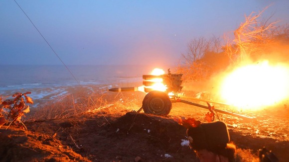 Soldiers of the Korean People's Army take part in a training exercise watched by Kim Jong-Un.