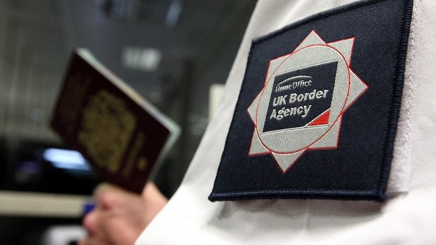 File photo of a UK Border Agent with a passport.