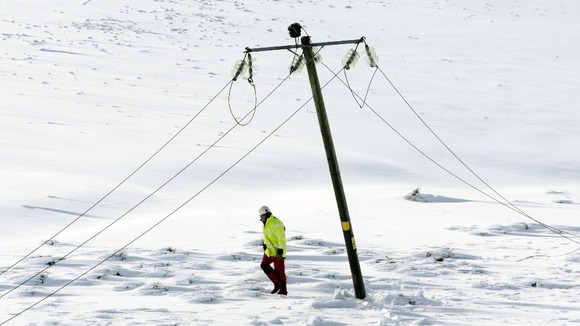 An engineer walks past a damaged power line in Kintyre in Scotland