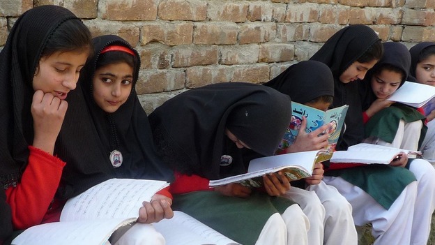 Girls read their schoolbooks in the Swat Valley in 2009