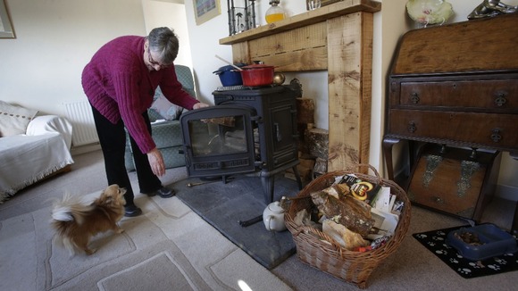 Janette Hamilton cooks on a wood burning stove at her home in Southend in Scotland after loosing her power supply