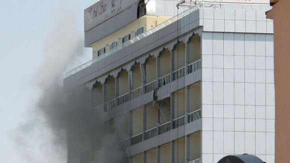 Smoke rises from a hotel after it was hit by a rocket-propelled grenade in Kabul