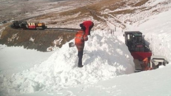Workers clearing snow from the Snowdonia Railway