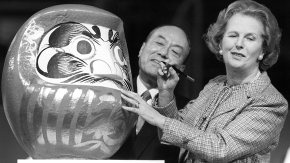 Former Prime Minister Margaret Thatcher seen in 1986 with the Daruma doll