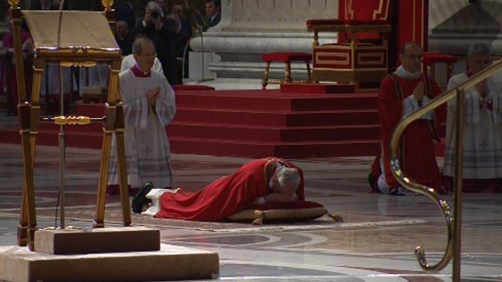 Pope Francis lies prostrate before the alter in St Peter's Basilica 