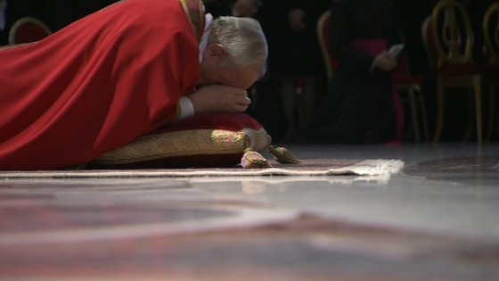 Pope Francis lies prostrate before the alter in St Peter's Basilica 