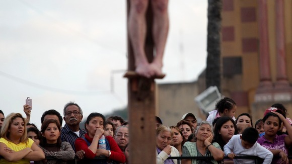 The actor playing Jesus is raised up above the pilgrims in Monterrey, Mexico.