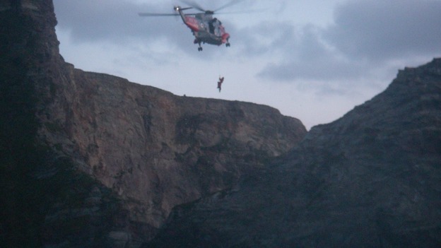 Helicopter winching person